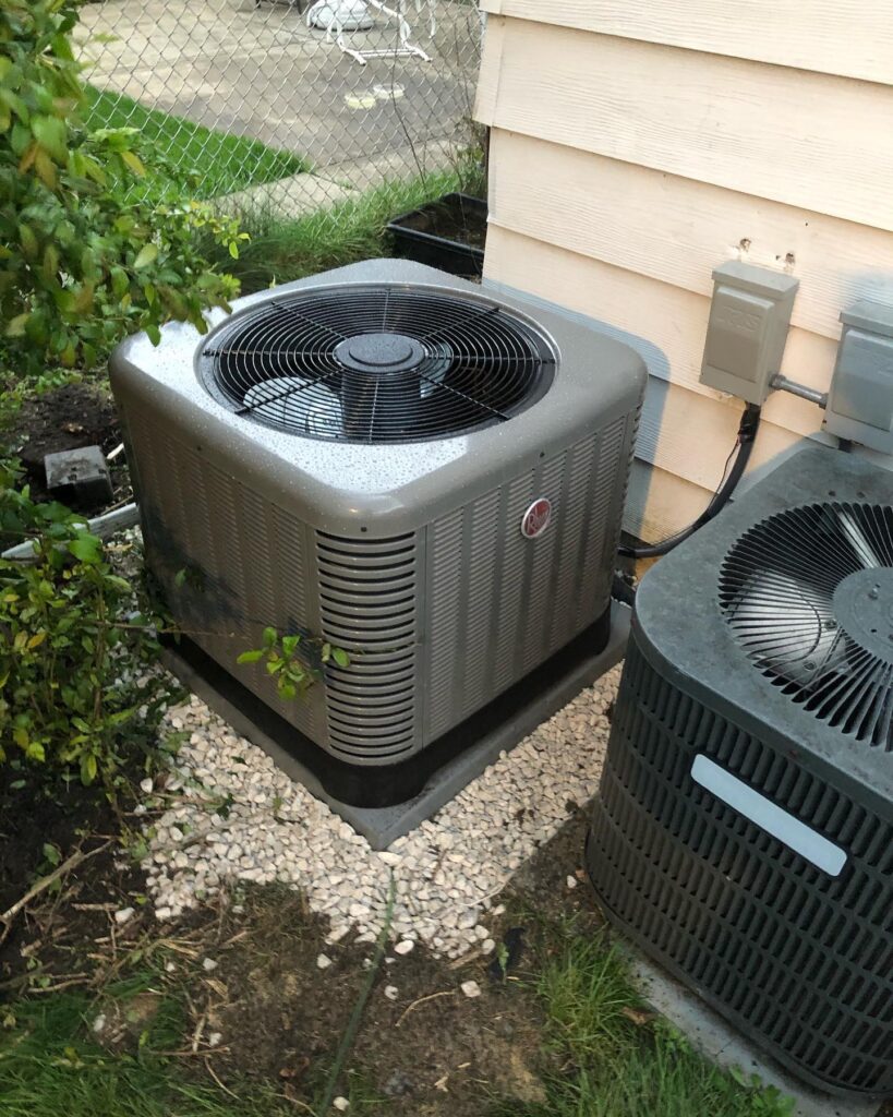 ThermoSTAT Heating & Cooling technician servicing residential HVAC unit outdoors