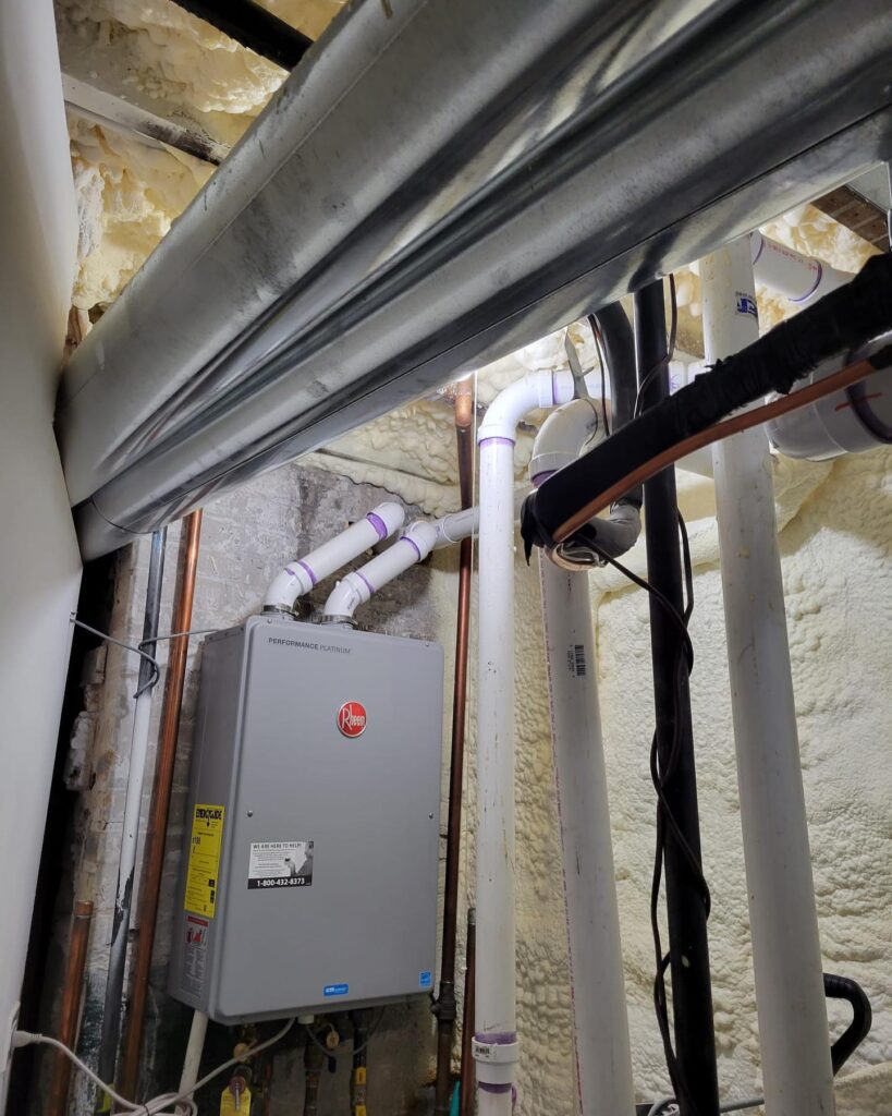 ThermoSTAT Heating & Cooling technician servicing gas furnace in Knoxville home