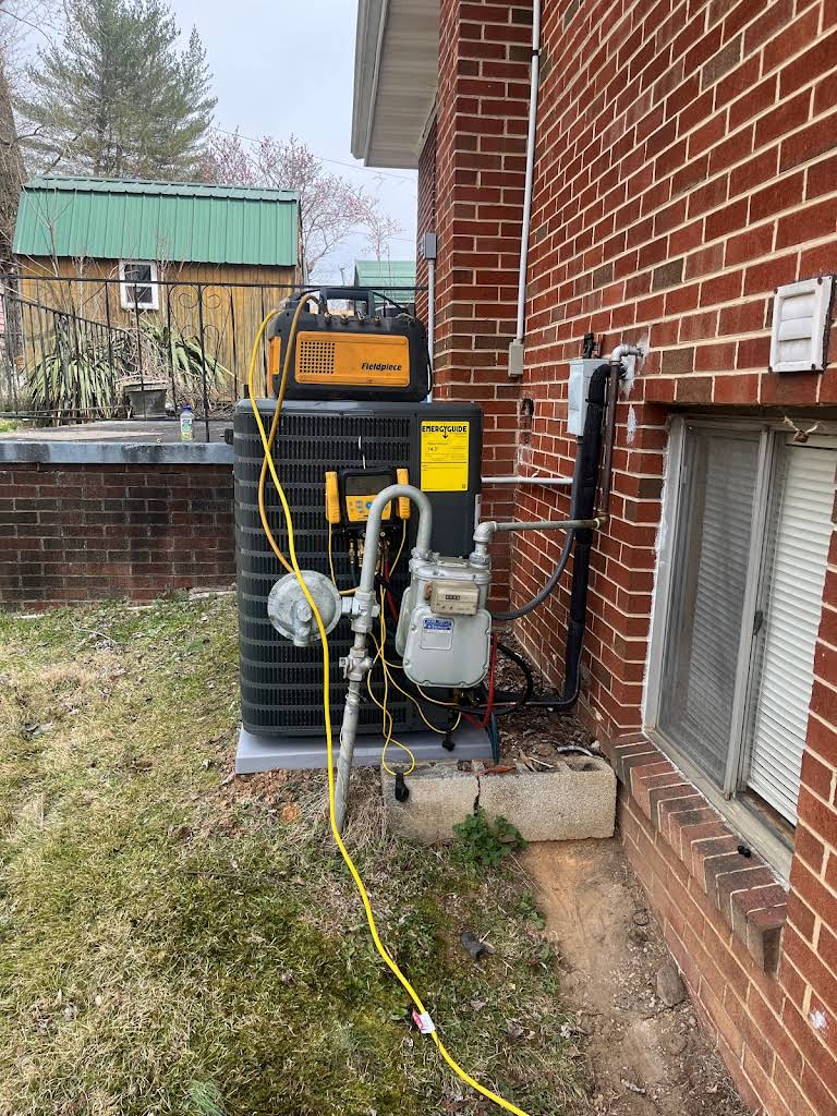 ThermoSTAT technician servicing air conditioning unit during summer projects