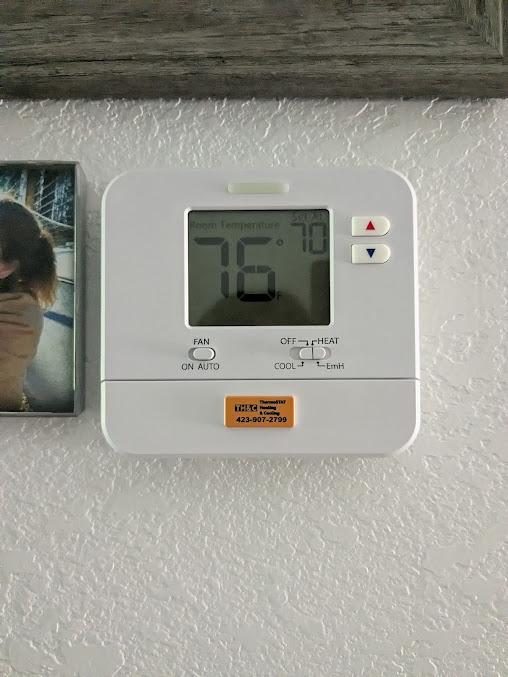 Trusted HVAC specialist servicing furnace and AC unit at local home exterior